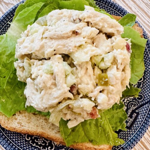 5 Delicous & Easy High-Protein Summer Snacks for Weight Loss 3 chicken salad scoop on a bed of lettuce on top of a blue china plate