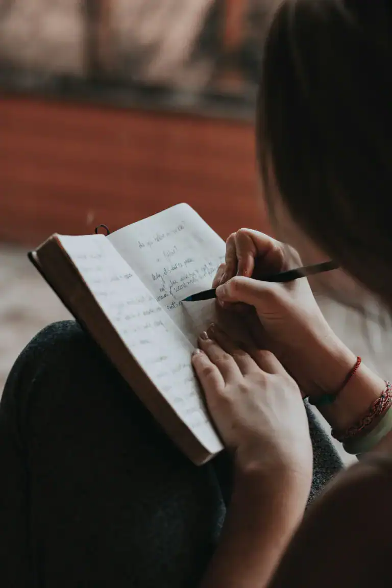The #1 Survival Guide for Going Dairy-free While Breastfeeding 12 lady-journaling in a book