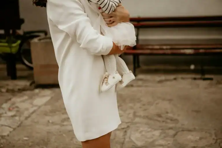 How To Glow-Up Postpartum: 5 Super Realistic Ways to Feel Like Yourself Again 1 mom holding her child in white clothes