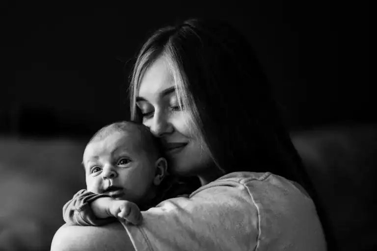 The #1 Survival Guide for Going Dairy-free While Breastfeeding 2 woman and newborn bonding, she is smelling her baby's head