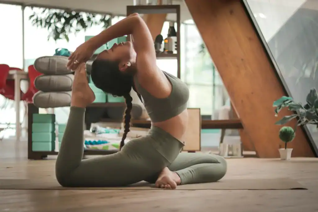 Revitalize Your Body: 7 Essential Postpartum Yoga Poses For New Moms 2 women doing an advanced form of yoga, a bit extreme for a postpartum yoga pose