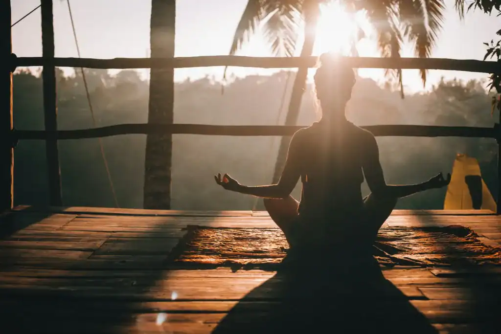 Revitalize Your Body: 7 Essential Postpartum Yoga Poses For New Moms 4 woman doing yoga by the sunrise, one of many fun postpartum yoga poses