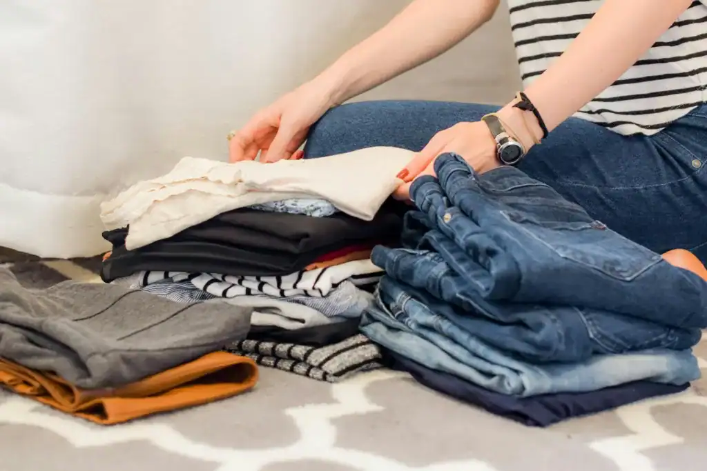 How To Glow-Up Postpartum: 5 Super Realistic Ways to Feel Like Yourself Again 7 woman folding jeans